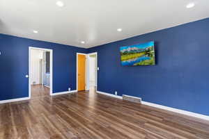 Unfurnished bedroom featuring dark wood-style flooring and recessed lighting