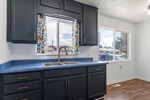 Kitchen with dark countertops and dark wood-type flooring