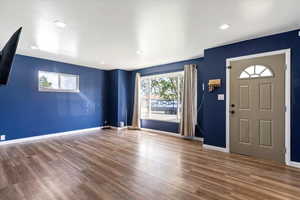 Entrance foyer with wood finished floors and recessed lighting
