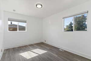 Empty room with dark wood-style flooring