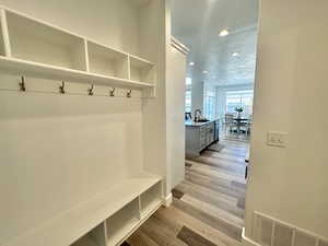 Mudroom featuring recessed lighting, light wood-style floors, and a textured ceiling