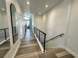 Stairs featuring recessed lighting and wood finished floors