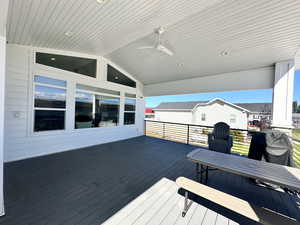 Wooden deck featuring ceiling fan and a grill