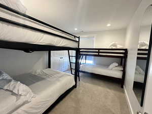 Bedroom with light carpet and recessed lighting