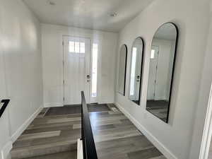 Entryway featuring dark wood-type flooring and baseboards