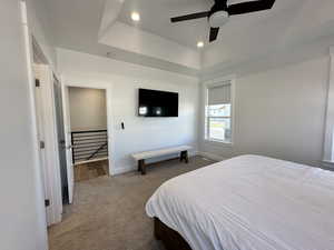 Bedroom featuring carpet floors, recessed lighting, a ceiling fan, and a raised ceiling