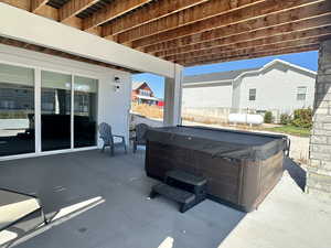 View of patio / terrace with a hot tub