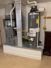 Utility room with water heater and heating unit