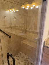 Bathroom featuring a stall shower and vanity