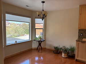 Unfurnished dining area featuring light wood-style floors and a chandelier