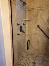 Full bath featuring a shower stall