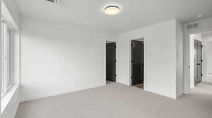Images shown are of a similar completed unit. Unfurnished bedroom with carpet floors and baseboards