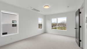 Images shown are of a similar completed unit. Spare room with carpet and baseboards