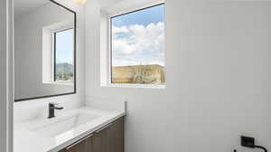 Images shown are of a similar completed unit. Bathroom featuring vanity