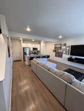 Living area featuring light wood-type flooring and recessed lighting