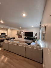 Living area with dark wood-style floors and recessed lighting