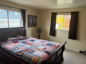 Carpeted bedroom featuring baseboards