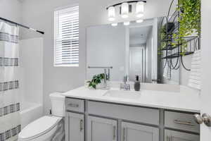 Bathroom with shower / bath combo and vanity