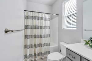 Bathroom with shower / bath combo and vanity