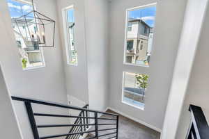 Stairs featuring carpe and a chandelier in entryway
