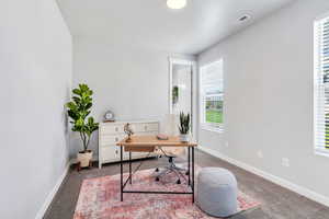 Bedroom #1 staged as an office with natural light & ensuite bathroom