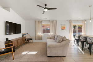 Living area with a ceiling fan and baseboards