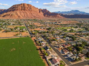 View of property location with a mountain backdrop and nearby suburban area