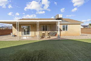 Back of house featuring stucco siding, a patio area, and a fenced backyard