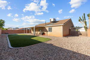 Back of property featuring a fenced backyard, a patio area, and stucco siding