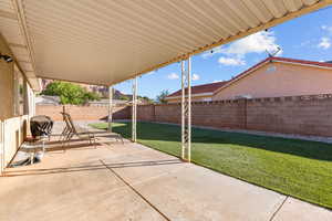 Fenced backyard with a patio