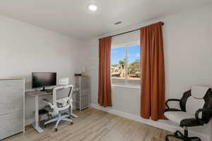 Office area featuring light wood-type flooring and baseboards