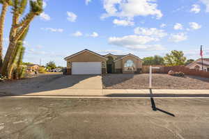 Ranch-style home featuring concrete driveway, a garage, and brick siding