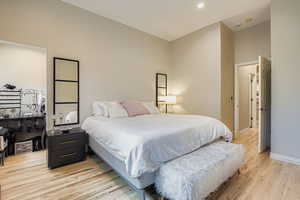 Bedroom with light wood-style floors and recessed lighting