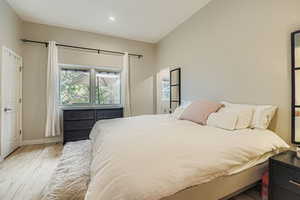 Bedroom with light wood-style flooring and recessed lighting