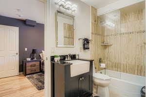 Bathroom with  shower combination, vanity, and light wood-style floors