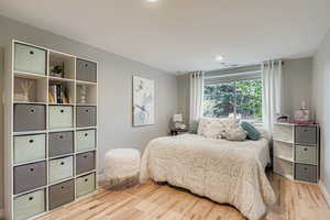 Bedroom featuring wood finished floors and recessed lighting