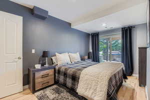 Bedroom featuring light wood-type flooring, access to outside, and recessed lighting