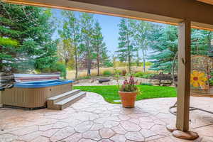 View of patio featuring a hot tub and a grill