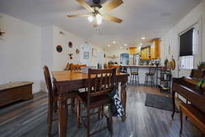 Dining space with dark wood-style floors, recessed lighting, and ceiling fan