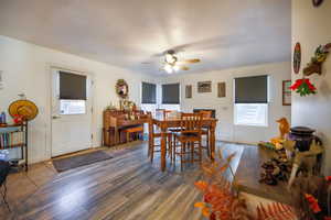 Dining area with wood finished floors and a ceiling fan