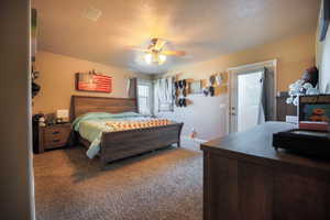 Bedroom with carpet, a ceiling fan, and access to outside