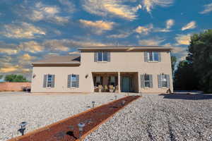 Back of property featuring a patio area and stucco siding