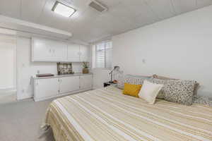Bedroom with light carpet and baseboards
