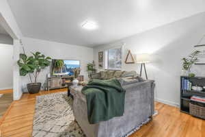 Living area featuring light wood-type flooring and baseboards