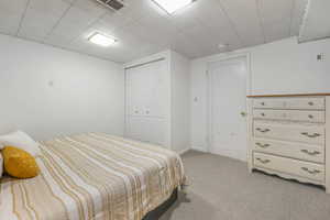 Bedroom featuring light carpet and a closet