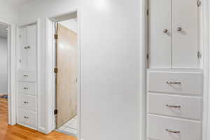 Corridor featuring light wood-style flooring