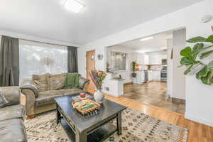 Living room featuring light wood-style floors and baseboards