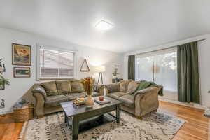 Living area with light wood-style flooring and baseboards