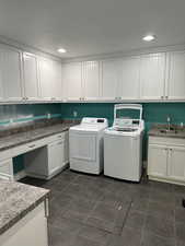 SECOND laundry room in the basement with cabinet space, washer and clothes dryer