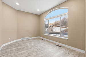 Office/front room with light wood-type flooring and recessed lighting